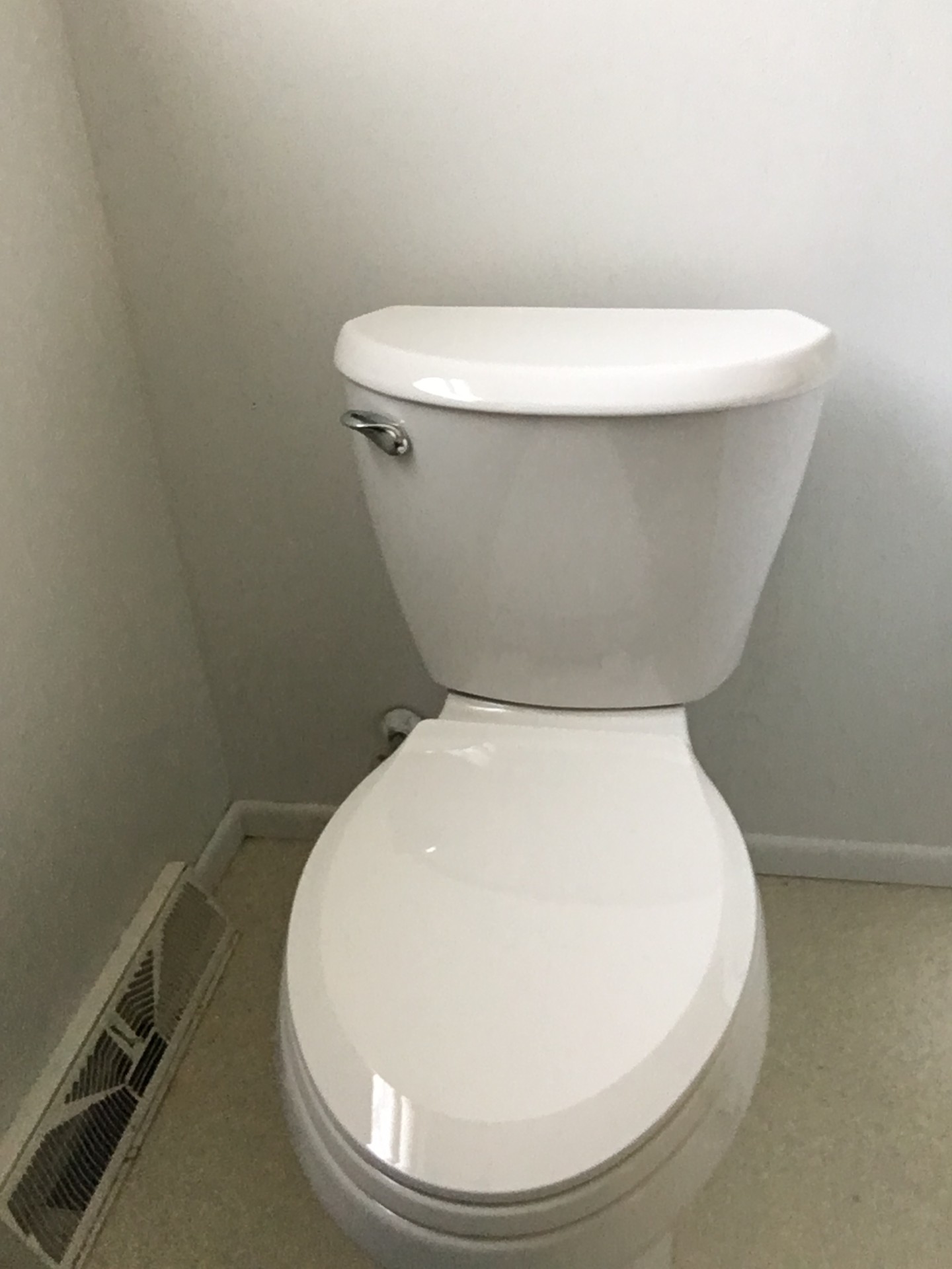 White toilet installed in a residential bathroom