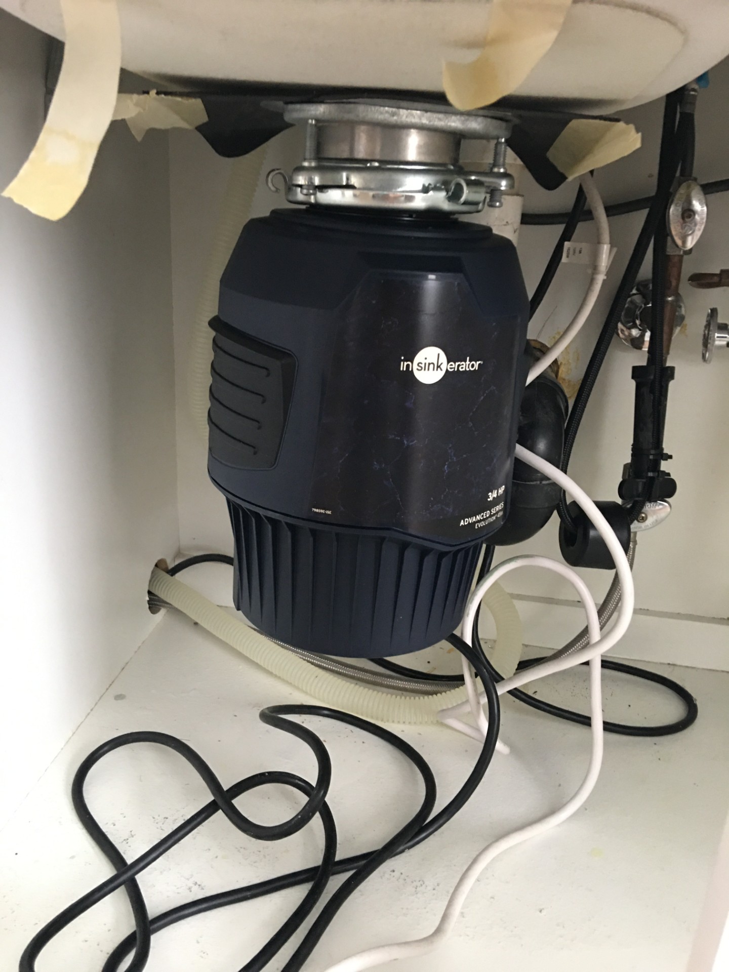 Garbage disposal installed beneath a kitchen sink